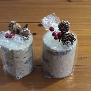2 holiday pillar candles with faux birch log look.